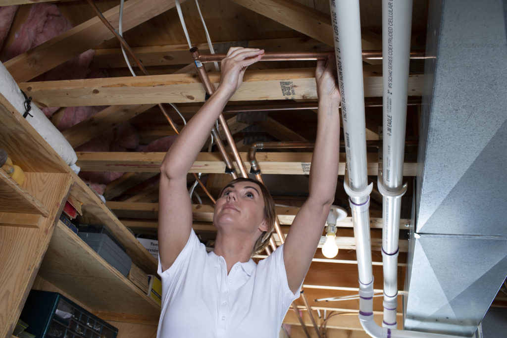 Plumber installing a new copper pipe