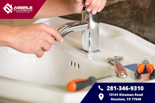 Someone repairing a bathroom sink faucet.