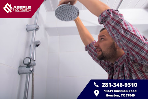 A man installing a shower head.